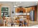 Eat-in kitchen with stainless steel appliances, granite countertops, and a corner window overlooking the backyard at 5683 Fig Way, Arvada, CO 80002