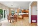 Open kitchen featuring wood cabinets, a center island, and a dining area with sliding doors to the backyard at 5683 Fig Way, Arvada, CO 80002