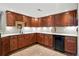 Elegant kitchenette with custom wood cabinets, granite countertops, and a wine refrigerator at 5683 Fig Way, Arvada, CO 80002
