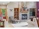 Cozy living room featuring a brick fireplace and built-in shelving for displaying decorative items at 5683 Fig Way, Arvada, CO 80002
