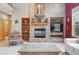 Cozy living room with a brick fireplace, built-in shelving, and comfortable seating at 5683 Fig Way, Arvada, CO 80002