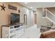 Spacious living room with cozy seating and a stylish entertainment center at 5683 Fig Way, Arvada, CO 80002