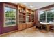 Home office featuring built-in bookshelves and a large window overlooking the landscaped backyard at 5683 Fig Way, Arvada, CO 80002