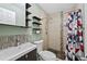 Modern bathroom features floating shelves, tiled walk-in shower with river rock floor and mosaic accents at 1530 W Berkeley Pl, Denver, CO 80221