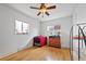 Bright bedroom features hardwood floors, ceiling fan, and natural light through large windows at 1530 W Berkeley Pl, Denver, CO 80221