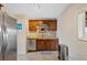 Functional kitchen featuring wooden cabinetry, stainless steel appliances, and tile flooring at 1530 W Berkeley Pl, Denver, CO 80221