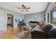 Bright living room with hardwood floors, ample natural light, and a stylish gray sectional sofa at 1530 W Berkeley Pl, Denver, CO 80221