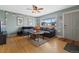 Cozy living room featuring a large gray sofa, stylish lighting, and hardwood floors at 1530 W Berkeley Pl, Denver, CO 80221