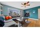 Inviting living room features a comfortable gray sectional, hardwood floors, and natural light at 1530 W Berkeley Pl, Denver, CO 80221