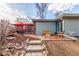 Spacious backyard with patio, steps, and lush landscaping at 1370 Upham St, Lakewood, CO 80214