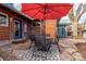 Landscaped backyard patio with dining table and red umbrella at 1370 Upham St, Lakewood, CO 80214