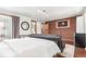 Contemporary bedroom featuring a brick accent wall, modern furnishings, and ample natural light at 1370 Upham St, Lakewood, CO 80214