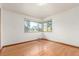 Bright bedroom with hardwood floors and a large window offering ample natural light at 1370 Upham St, Lakewood, CO 80214