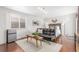 Cozy bedroom with a sleek black futon, accent furniture, and large window at 1370 Upham St, Lakewood, CO 80214