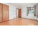 Well-lit empty bedroom with hardwood floors, a closet, and a window with curtains at 1370 Upham St, Lakewood, CO 80214