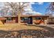 Charming brick home with large windows and manicured lawn, creating a welcoming curb appeal at 1370 Upham St, Lakewood, CO 80214