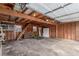 Spacious garage featuring wooden walls, concrete flooring, and ample storage space at 1370 Upham St, Lakewood, CO 80214