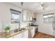 Modern kitchen with stainless steel appliances, granite countertops, and updated white cabinetry at 1370 Upham St, Lakewood, CO 80214