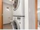 Efficient laundry area features a stacked washer and dryer with adjacent toilet and a small window at 1370 Upham St, Lakewood, CO 80214