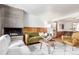 Cozy living room featuring a stone fireplace, modern furniture, and stylish decor on hardwood flooring at 1370 Upham St, Lakewood, CO 80214