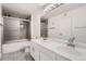 Bathroom with double vanity, white cabinets, and a tub shower combo at 9963 E Carolina Cir # 202, Aurora, CO 80247