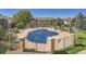 Community pool with safety cover, surrounded by a fence and patio furniture at 9963 E Carolina Cir # 202, Aurora, CO 80247