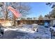 Snow-covered backyard featuring a grill, seating, a fire pit, and a wooden fence at 13068 Harrison Dr, Thornton, CO 80241