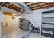 Unfinished basement with exposed ceiling, shelving, and concrete floor at 13068 Harrison Dr, Thornton, CO 80241