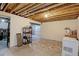 Unfinished basement space with exposed ceiling, concrete flooring, and ample storage at 13068 Harrison Dr, Thornton, CO 80241