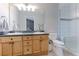 Bathroom with double sink vanity, plenty of cabinet storage, and a glass-enclosed shower at 13068 Harrison Dr, Thornton, CO 80241