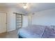 Well-lit bedroom features a barn door leading to the ensuite bathroom at 13068 Harrison Dr, Thornton, CO 80241