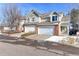 Charming townhome with a two-car garage and brick accents on a sunny day at 13068 Harrison Dr, Thornton, CO 80241