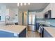 Well-lit kitchen featuring modern stainless steel appliances and a stylish island at 13068 Harrison Dr, Thornton, CO 80241