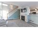 Inviting living room with a fireplace, mounted TV, and an open view into the kitchen at 13068 Harrison Dr, Thornton, CO 80241