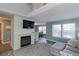 Comfortable living room with a fireplace, television, and view of the dining area at 13068 Harrison Dr, Thornton, CO 80241