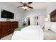 Bedroom featuring a closet, a ceiling fan, and a flat-screen TV at 3082 S Wheeling Way # 410, Aurora, CO 80014