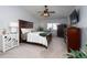 Bright bedroom featuring a ceiling fan, a window, and wood furniture at 3082 S Wheeling Way # 410, Aurora, CO 80014