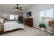 Bedroom with neutral carpet, a large window, and two wooden dressers at 3082 S Wheeling Way # 410, Aurora, CO 80014