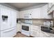 Efficient kitchen featuring white cabinetry, stainless steel appliances and tile floor at 3082 S Wheeling Way # 410, Aurora, CO 80014