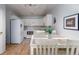 Efficient kitchen with white cabinets, modern appliances, and adjacent dining area at 3082 S Wheeling Way # 410, Aurora, CO 80014