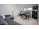 Cozy living room featuring a comfortable sofa and a well-lit desk with houseplants at 3082 S Wheeling Way # 410, Aurora, CO 80014