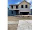 Two-story home with blue siding and an attached two car garage is under construction at 15254 Milwaukee St, Thornton, CO 80602