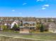 Aerial view of a well-planned community, highlighting the homes, mature trees, and a three-car garage at 1936 Alpine Dr, Erie, CO 80516
