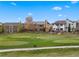 The backyard of a row of houses has views of the neighborhood golf course at 1936 Alpine Dr, Erie, CO 80516