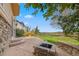 Inviting outdoor space with a stone patio, a fire pit, and lush landscaping for relaxing and entertaining at 1936 Alpine Dr, Erie, CO 80516