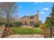Spacious backyard with a stone patio, a well-manicured lawn, and mature landscaping at 1936 Alpine Dr, Erie, CO 80516