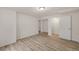 Finished basement space with wood-look flooring, white walls, and an open doorway at 1936 Alpine Dr, Erie, CO 80516