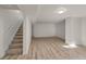 Finished basement featuring wood-look flooring, white walls and staircase with natural light at 1936 Alpine Dr, Erie, CO 80516