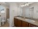 Bathroom featuring a double sink vanity and a bathtub with tiled wall at 1936 Alpine Dr, Erie, CO 80516