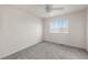 Cozy bedroom featuring plush gray carpet, neutral walls, and a ceiling fan at 1936 Alpine Dr, Erie, CO 80516